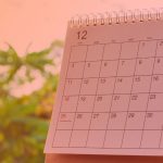 a calendar month with trees in the background