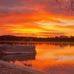 looking out on the lake with the sunrise lighting the sky