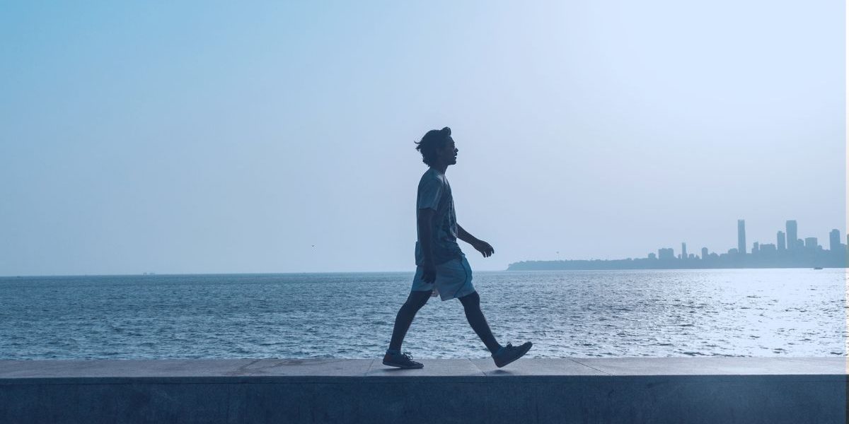 a person walking by the water