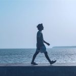 a person walking by the water