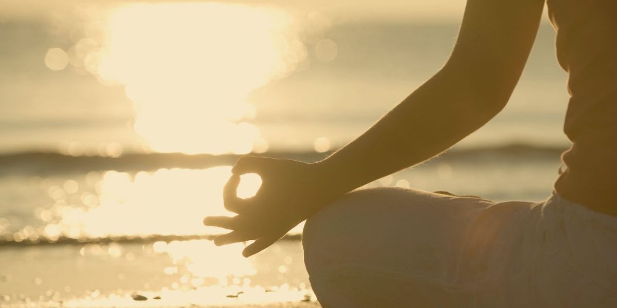 Person meditating and enjoying time with themselves in the sun
