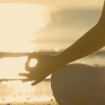 Person meditating and enjoying time with themselves in the sun