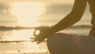 Person meditating and enjoying time with themselves in the sun
