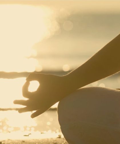 Person meditating and enjoying time with themselves in the sun