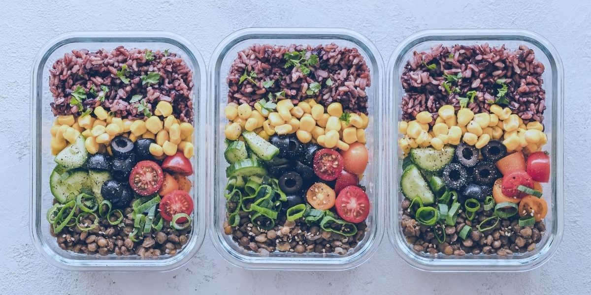 nicely organized meal prep containers full of colorful nutrients