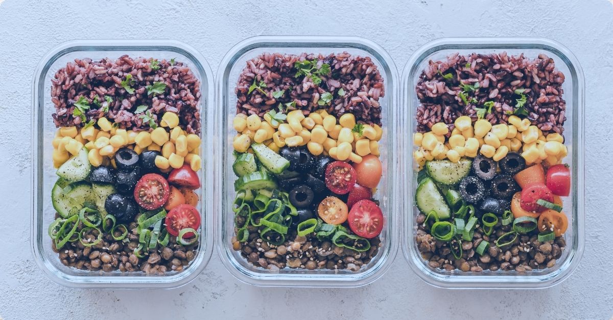 nicely organized meal prep containers full of colorful nutrients