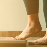 person stepping up on a scale