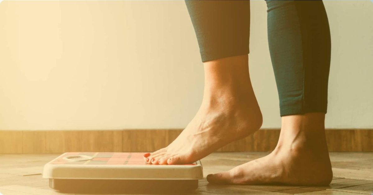 person stepping up on a scale